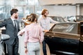 Couple choosing a new car in the showroom Royalty Free Stock Photo