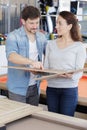 couple choosing options for new pool table Royalty Free Stock Photo