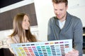 Couple choosing paint colour from swatch