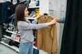 Couple choosing shirts in fitting room, store