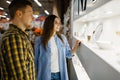 Couple choosing wine glasses in houseware store