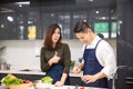 Couple chopped vegetables for the boyfriend in the kitchen. Young couples are helping to chop vegetables in the kitchen. Asian Royalty Free Stock Photo