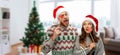 Couple with christmas party props in ugly sweaters Royalty Free Stock Photo