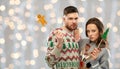 Couple with christmas party props in ugly sweaters Royalty Free Stock Photo