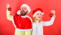 Couple christmas santa costume hold ornament ball. Christmas decoration tradition. Woman and bearded man in santa hat Royalty Free Stock Photo