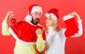 Couple christmas santa costume hold sock and ornament ball. Christmas stocking tradition. Christmas celebration concept