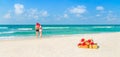 Couple in Christmas Santa hats at beach with holiday gifts Royalty Free Stock Photo