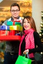 Couple Christmas shopping with presents in mall Royalty Free Stock Photo