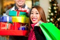 Couple Christmas shopping with presents in mall Royalty Free Stock Photo