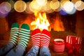 Couple in Christmas socks near fireplace Royalty Free Stock Photo