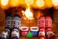 Couple in Christmas socks near fireplace Royalty Free Stock Photo