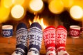 Couple in Christmas socks near fireplace Royalty Free Stock Photo