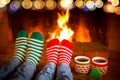 Couple in Christmas socks near fireplace Royalty Free Stock Photo