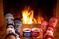 Couple in Christmas socks near fireplace Royalty Free Stock Photo