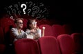 Couple in cinema with questions Royalty Free Stock Photo