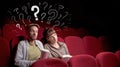 Couple in cinema with questions Royalty Free Stock Photo