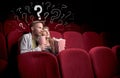 Couple in cinema with questions Royalty Free Stock Photo