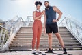 Couple, city stairs and portrait for fitness with headphones, music and motivation for urban workout together. Exercise Royalty Free Stock Photo