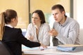 Couple claiming to a businesswoman at office Royalty Free Stock Photo