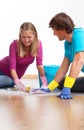 Couple cleaning the floor