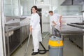 Couple cleaning kitchen surfaces and cupboards together Royalty Free Stock Photo