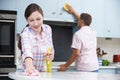 Couple Cleaning Kitchen Surfaces And Cupboards Together Royalty Free Stock Photo