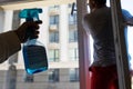 Couple Cleaning a Window Using Sprayed Liquid. Royalty Free Stock Photo