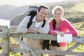 Couple on cliffside outdoors leaning on railing Royalty Free Stock Photo