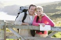 Couple on cliffside outdoors leaning on railing Royalty Free Stock Photo