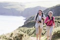 Couple on cliffside outdoors walking and smiling Royalty Free Stock Photo