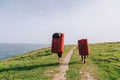 Couple of climbers walking with crash pads at the coast