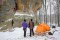 Couple climbers in a winter time near the mountain camping