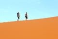 Couple climbing Dune 45, Sossusvlei Namibia Royalty Free Stock Photo