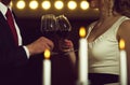 Couple clink glasses with red wine at meeting or wedding