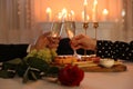 Couple clinking glasses of champagne in restaurant, closeup. Romantic dinner Royalty Free Stock Photo