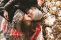 Couple close lying on plaid in winter park