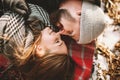 Couple close lying on plaid in winter park