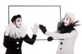 Two clowns cleaning an empty picture