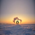 Couple in cold winter morning play with snow. Shape of heart, valentine postcard