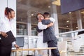 Couple collecting new car from salesman on lot Royalty Free Stock Photo