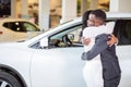 Couple collecting new car from salesman on lot Royalty Free Stock Photo