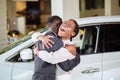 Couple collecting new car from salesman on lot Royalty Free Stock Photo