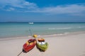 Couple of colorful kayak boats on white sand beach blue sea and clear sky with clouds Royalty Free Stock Photo