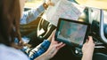 Couple comparing paper map and a gps navigator Royalty Free Stock Photo