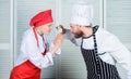 Couple compete in culinary arts. Who cook better. Culinary battle concept. Woman and bearded man culinary show Royalty Free Stock Photo