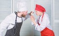 Couple compete in culinary arts. Who cook better. Culinary battle concept. Woman and bearded man culinary show Royalty Free Stock Photo