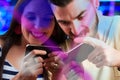 Couple competes in smartphone gaming, exuding excitement Royalty Free Stock Photo