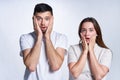 Couple confused scary emotion over gray background