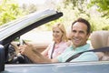 Couple in convertible car smiling Royalty Free Stock Photo