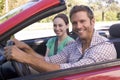 Couple in convertible car smiling Royalty Free Stock Photo